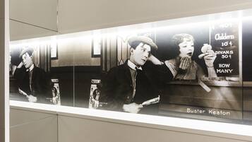 A vintage movie poster with a man holding a cigarette and a woman in the background.
