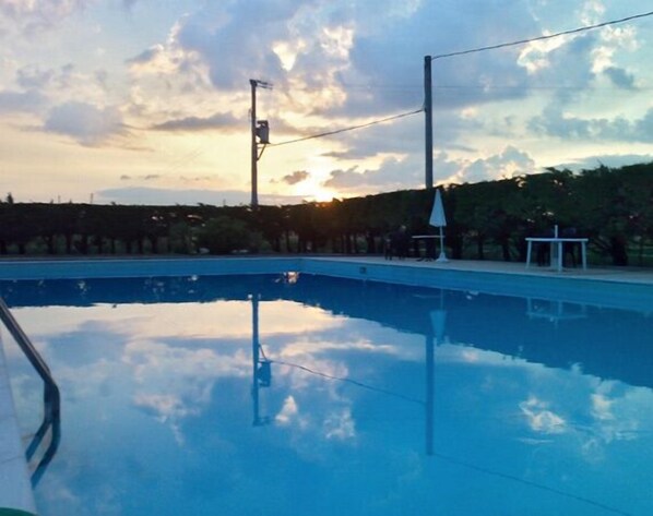 Seasonal outdoor pool, open 9 AM to 7:30 PM, pool umbrellas