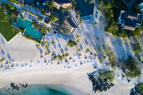 On the beach, white sand, sun loungers, beach umbrellas