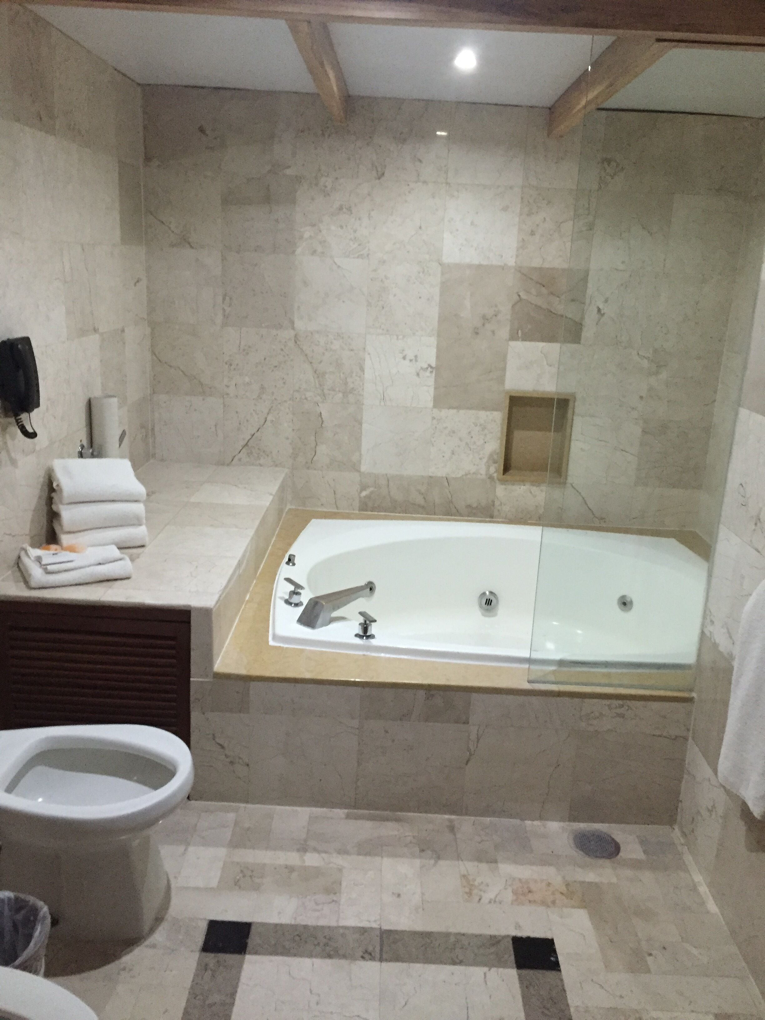 A bathroom with a bathtub, toilet, and sink.