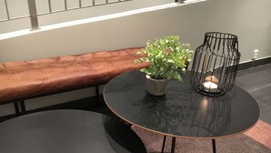 A round table with a potted plant and a candle holder.