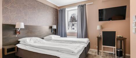A modern hotel room with a large bed, two bedside tables, a TV, and a view of the outside.