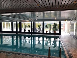 Indoor pool, open 7:00 AM to 7:00 PM, pool loungers
