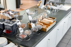 A buffet with various food items and condiments.