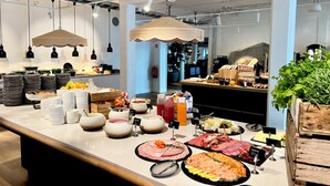 A buffet setup with various food items and serving dishes. - Havna Hotel & Sjøbad (Færder)