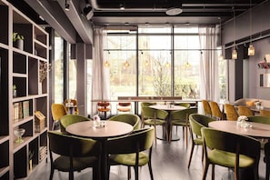 Enjoy casual dining in a well-maintained space with round tables and comfortable chairs.