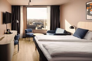 Relax in a stylish room with a large bed, desk, and city view.