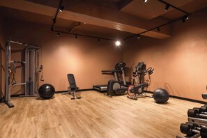 Work out in style with a range of fitness equipment, including a weight bench, stationary bike, and treadmill.