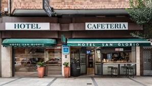 A hotel and cafe with a sign reading "HOTEL SAN GLORIO" and a reception area visible through the glass. - Hotel San Glorio (Santander)