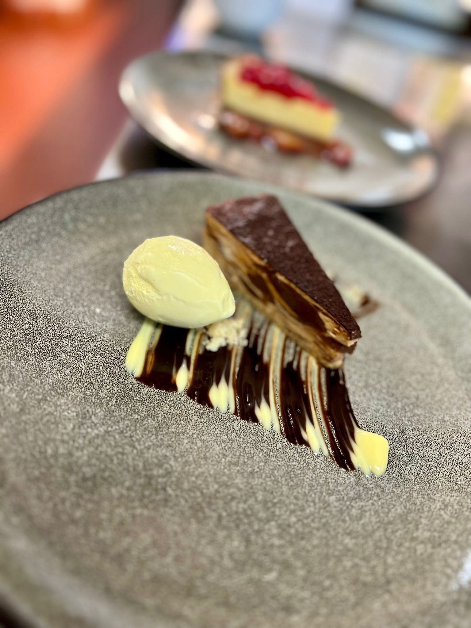 A dessert with chocolate and a scoop of ice cream on a plate.