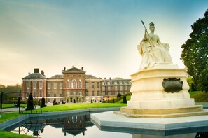 A grand building with classical architecture, a statue in the foreground, and a reflective water feature. - Holiday Inn Express London Victoria by IHG (London)