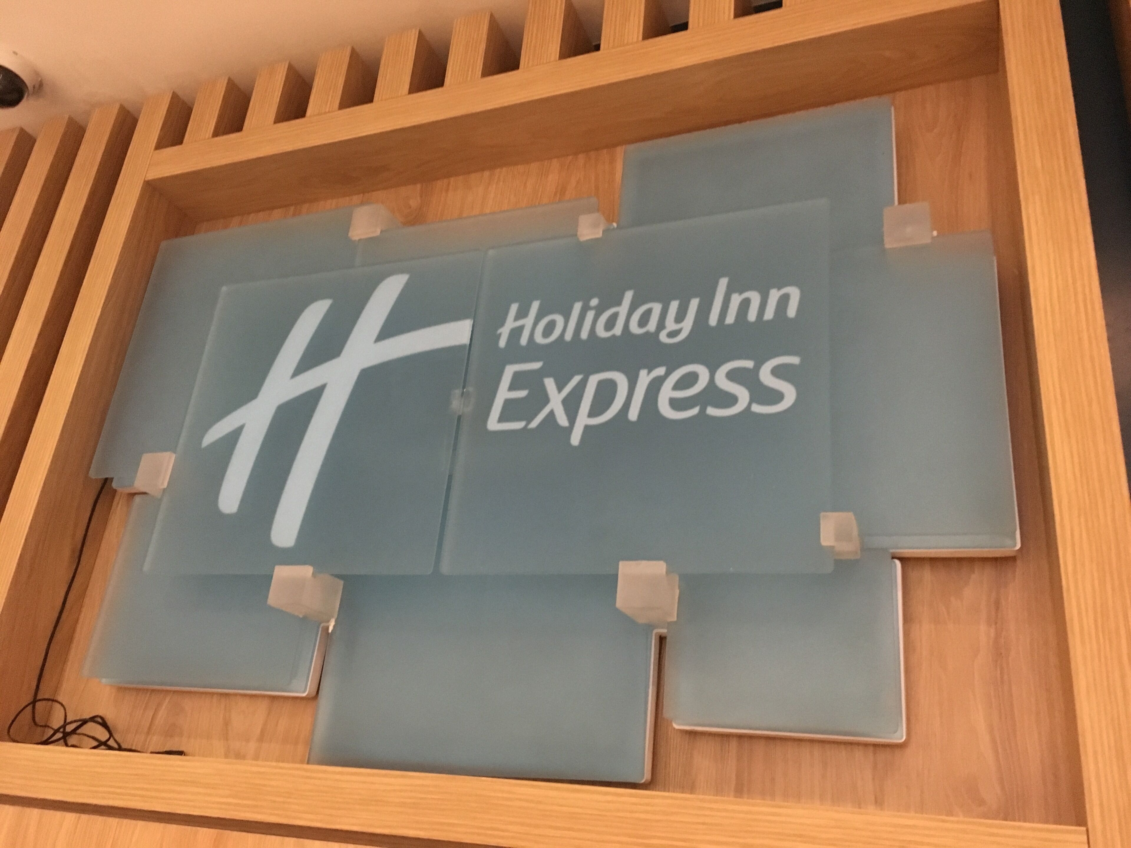 A Holiday Inn Express sign with a wooden frame and a blue background.