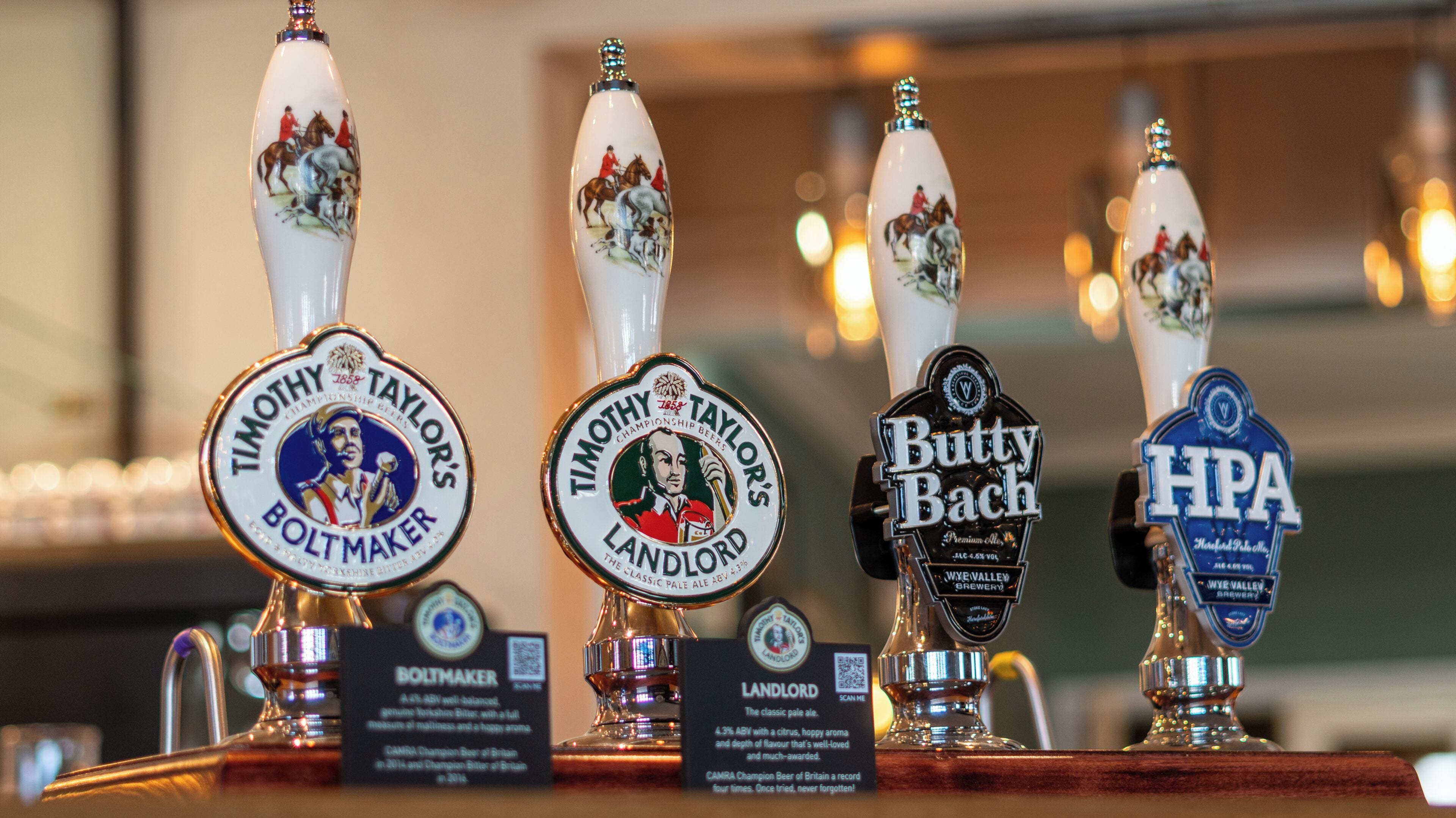 A selection of beer taps with labels indicating different brands and types.
