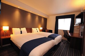 A hotel room with two beds, a desk, a chair, and a large window. - Holiday Inn Express Glenrothes by IHG (Glenrothes)