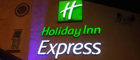 A Holiday Inn Express sign with a green logo and white lettering.