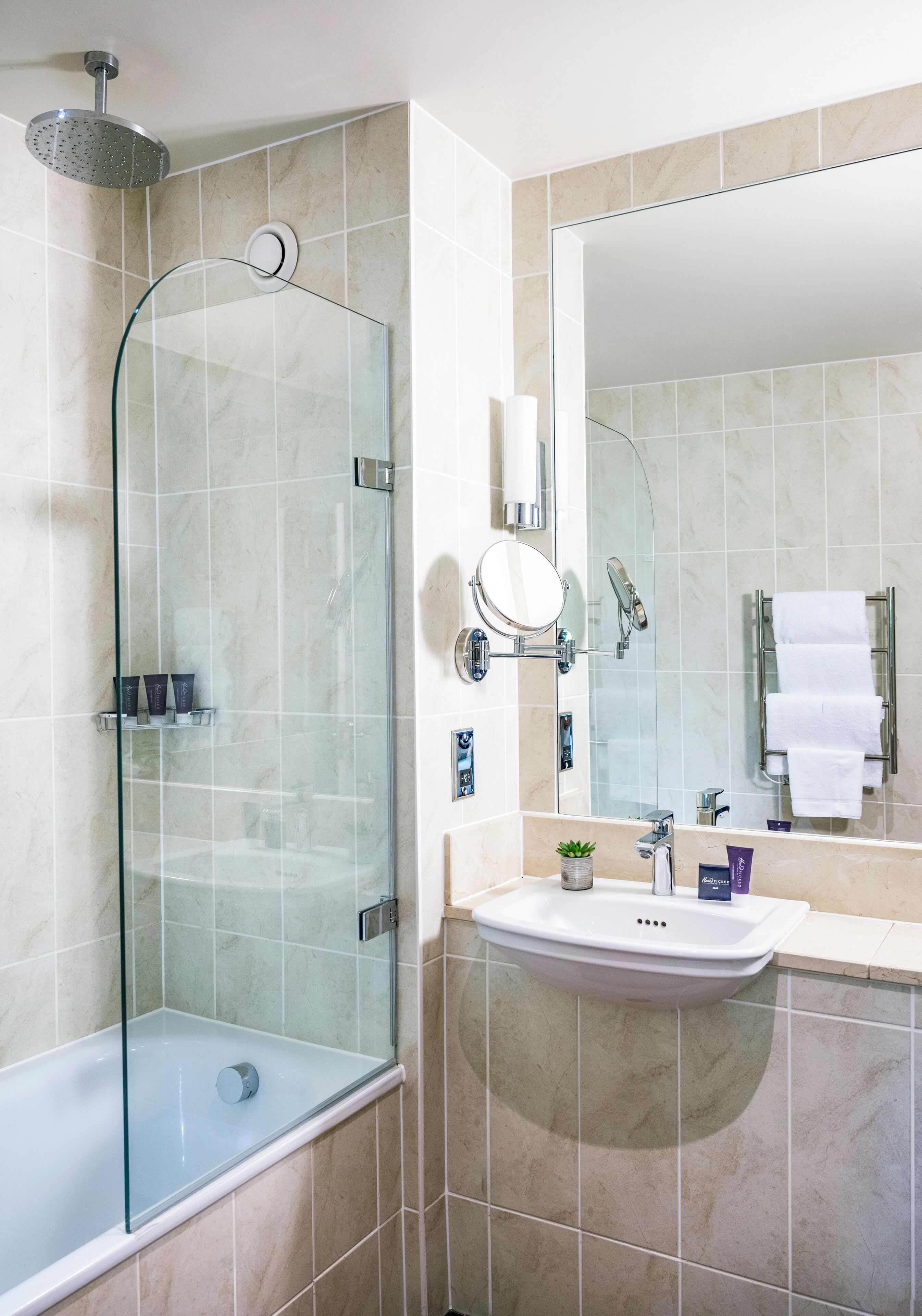 designer toiletries, hair dryer, bathrobes, slippers