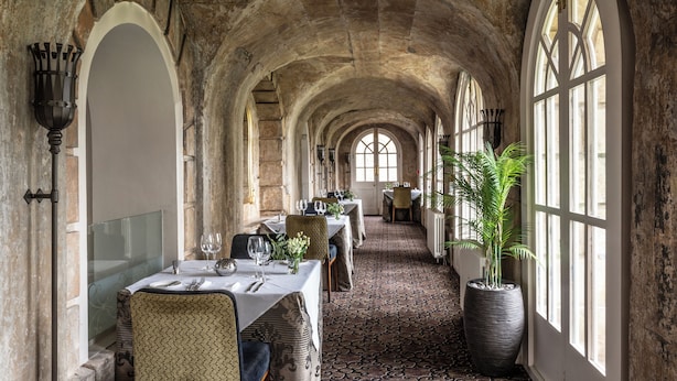 A long corridor with arched ceilings and large windows, lined with tables set for dining. - Bailbrook House (Bath)