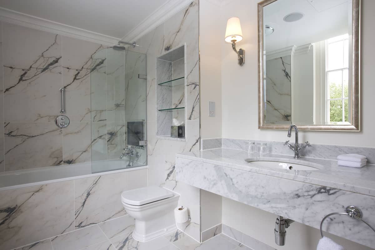 deluxe king bedded room in historic mansion house | bathroom | designer toiletries, hair dryer, bathrobes, slippers