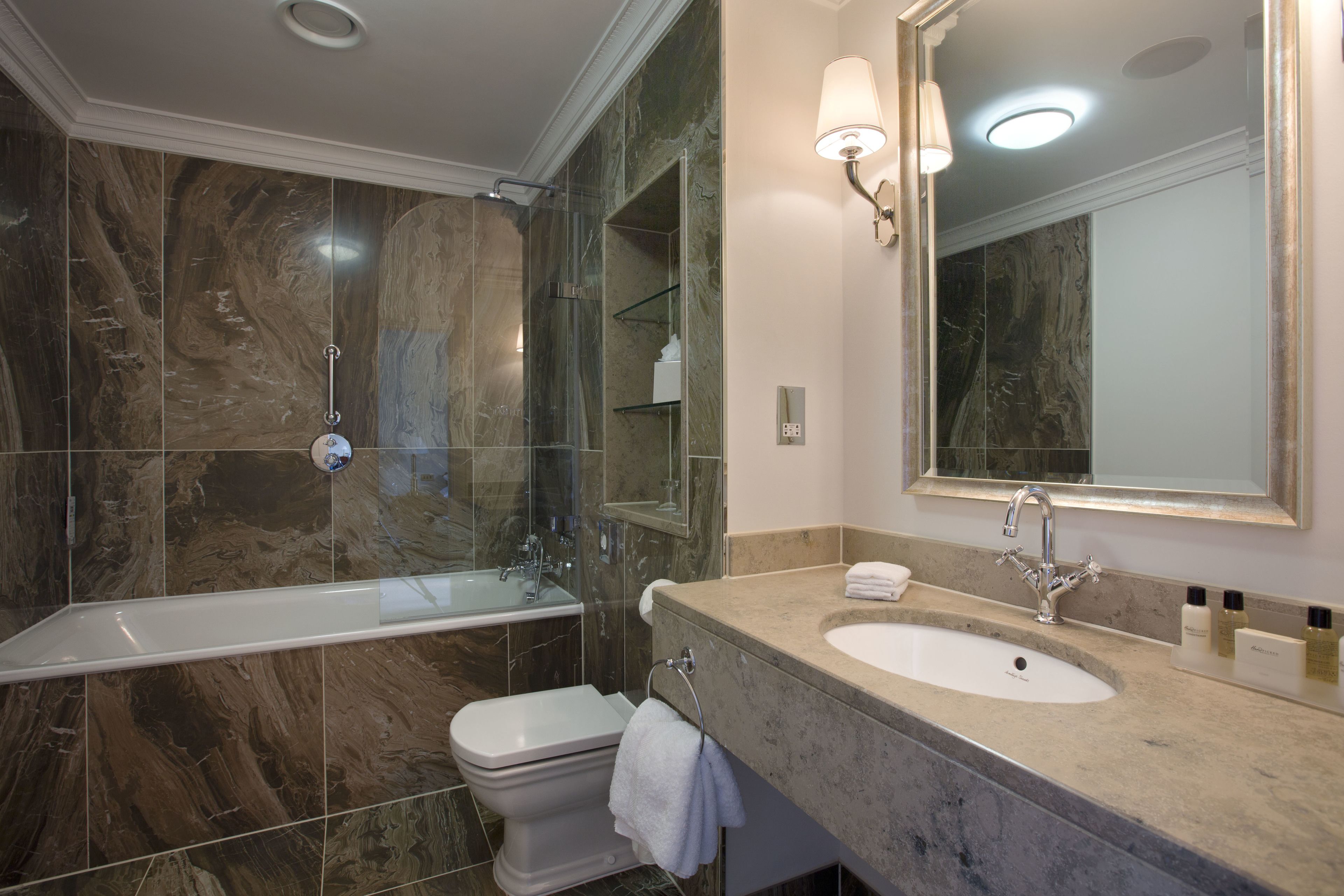 deluxe king bedded room in historic mansion house | bathroom | designer toiletries, hair dryer, bathrobes, slippers