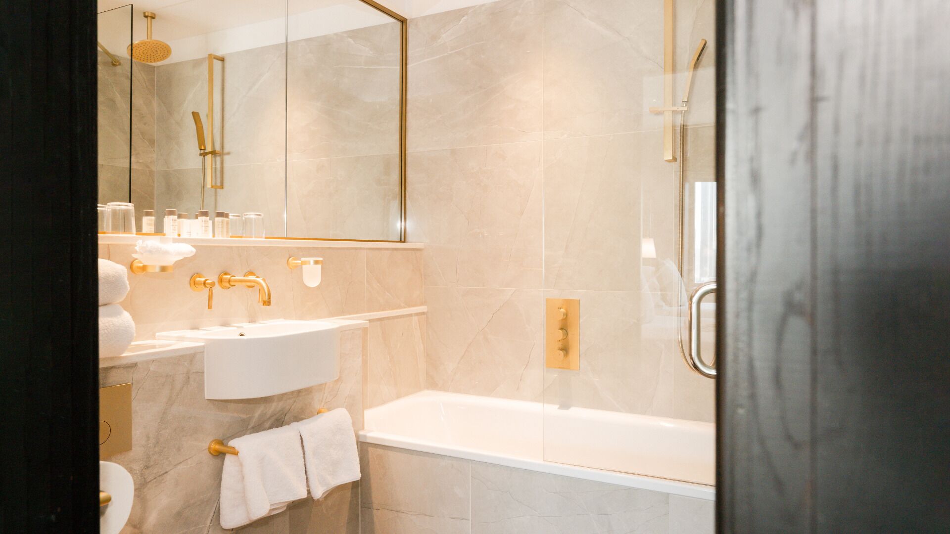 A modern bathroom with a bathtub, a sink, and a shower area.