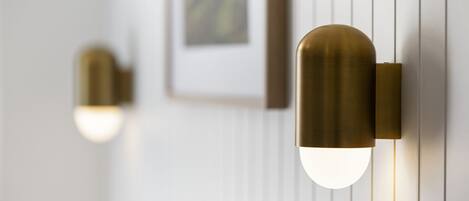 A wall-mounted light fixture with a spherical design and a visible bulb.