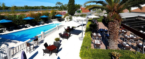 Seasonal outdoor pool, open 8:00 AM to 8:00 PM, pool loungers