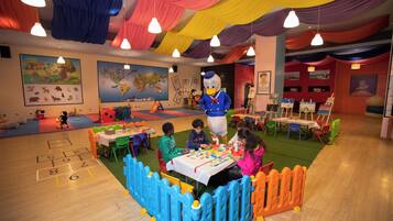 Children can play and learn in this vibrant space with a mascot, murals, and a play area.
