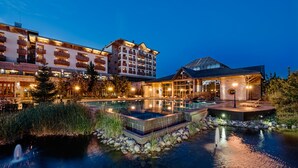 A resort with a swimming pool, a spa area, and multiple buildings with balconies.