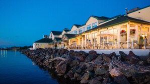 A waterfront hotel with outdoor seating and a view of the water. - Rodd Miramichi (Miramichi)