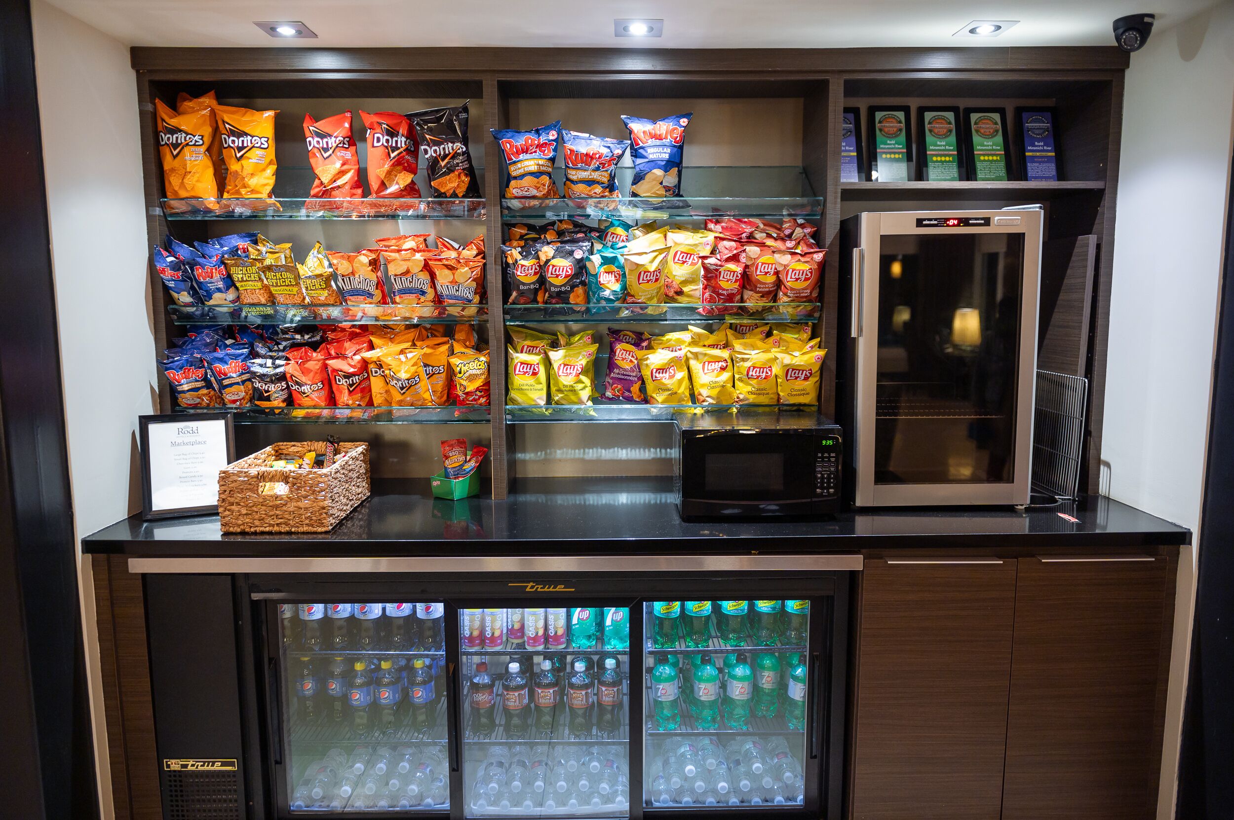A snack and beverage vending area with various chips and drinks.