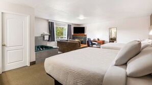 A hotel room with a bed, a desk, a chair, a TV, and a bathroom. - Days Inn by Wyndham Valemount (Valemount)