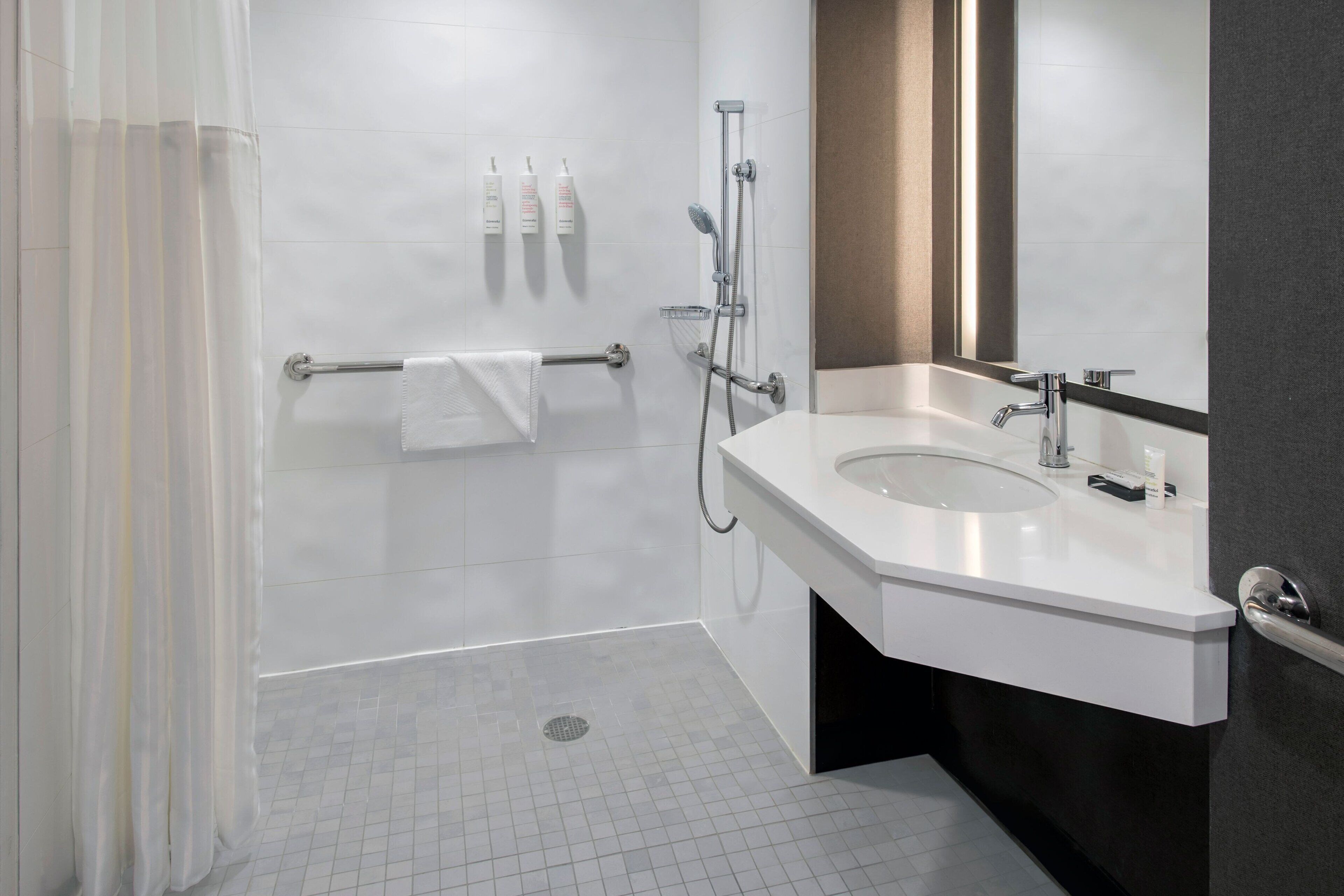 combined shower/bathtub, designer toiletries, hair dryer, towels