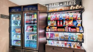 A vending machine with a variety of snacks and beverages, including chips, sodas, and energy drinks.