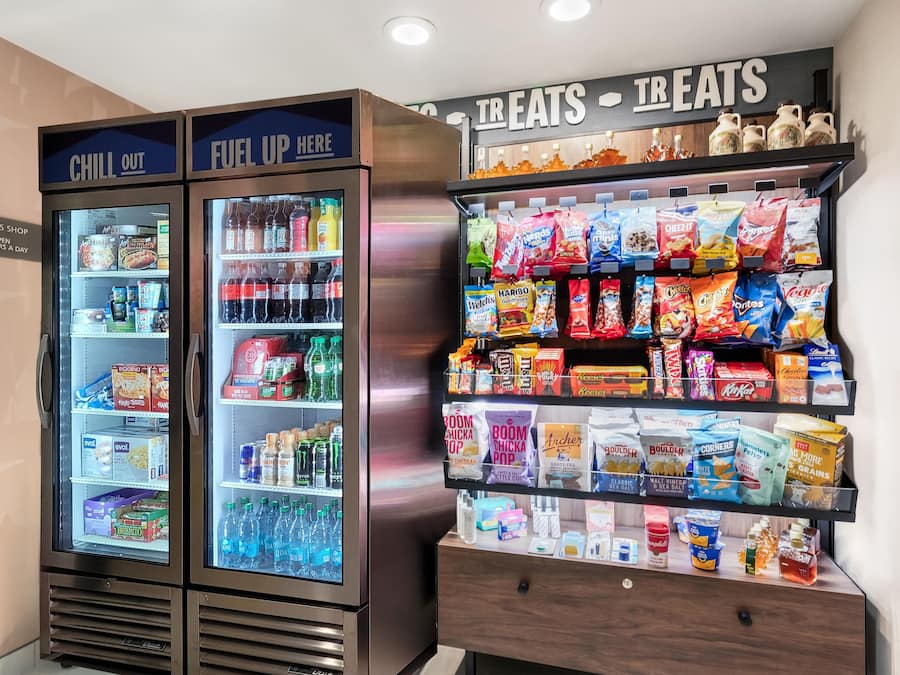 A vending machine with a variety of snacks and beverages, including chips, sodas, and energy drinks.
