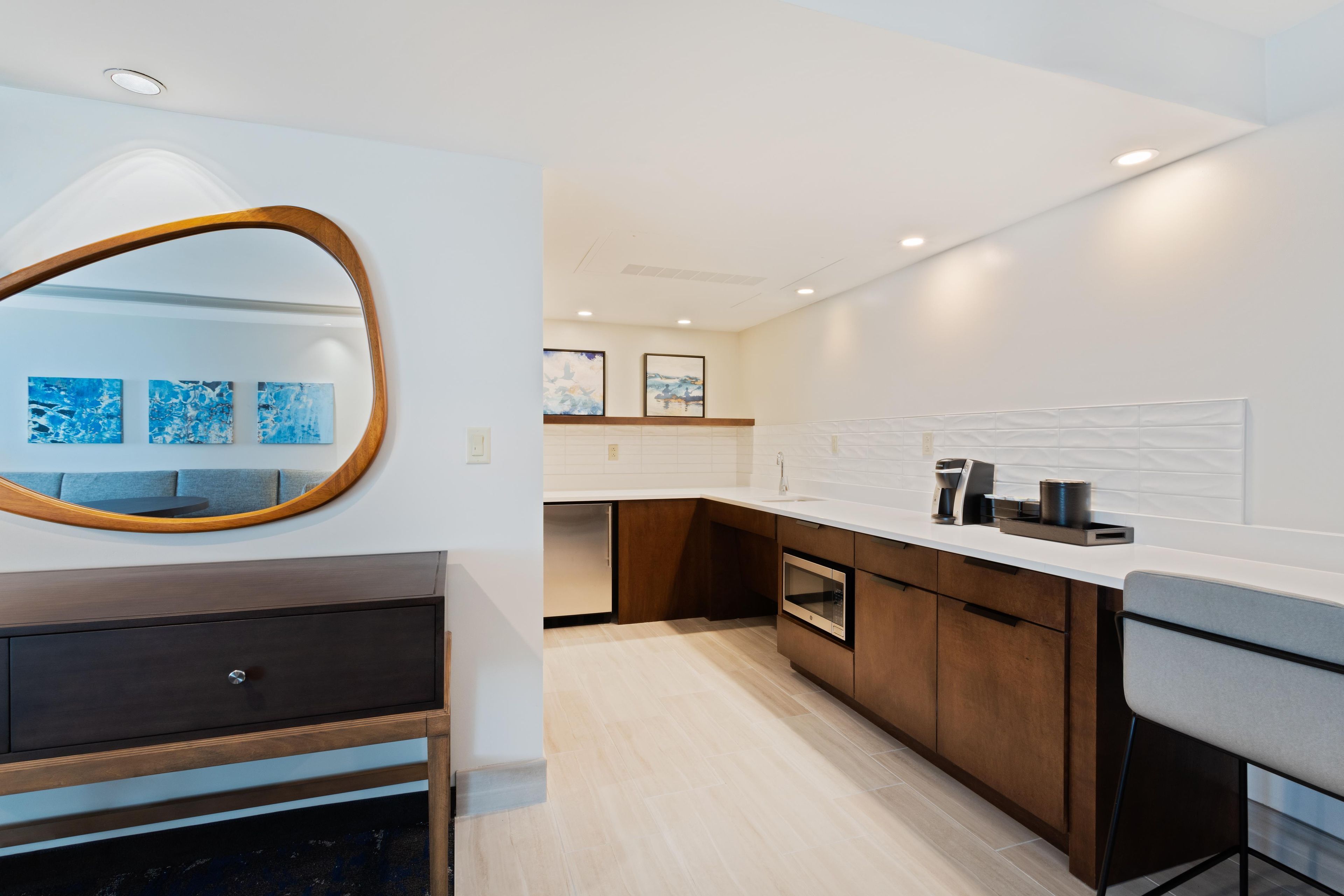 A modern kitchen with a built-in oven, a coffee machine, and a sink.
