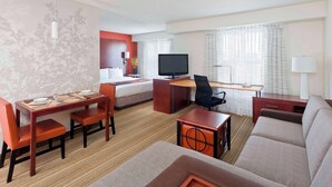 A hotel room with a dining area, a sofa, a TV, and a desk. - Residence Inn Waco (Waco)