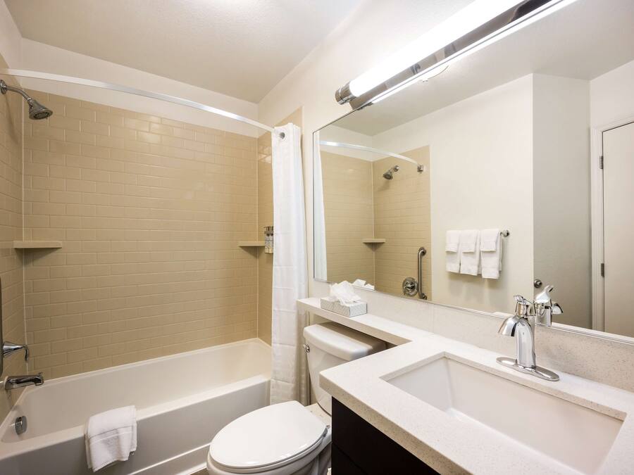 A modern bathroom with a bathtub, toilet, and sink.