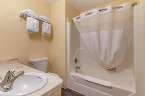 A bathroom with a sink, toilet, and bathtub.