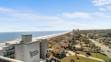 A coastal hotel with a view of the beach and ocean.