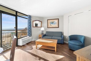 Ocean View King | Living area | 30-inch flat-screen TV with cable channels, TV - Monterey Bay Suites (Myrtle Beach)