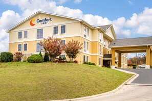 A Comfort Inn hotel with a two-story structure, a covered entrance, and a parking area.