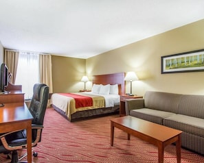 A hotel room with a bed, a desk, a chair, a sofa, and two bedside lamps. - Comfort Inn Poplar Bluff North (Poplar Bluff)