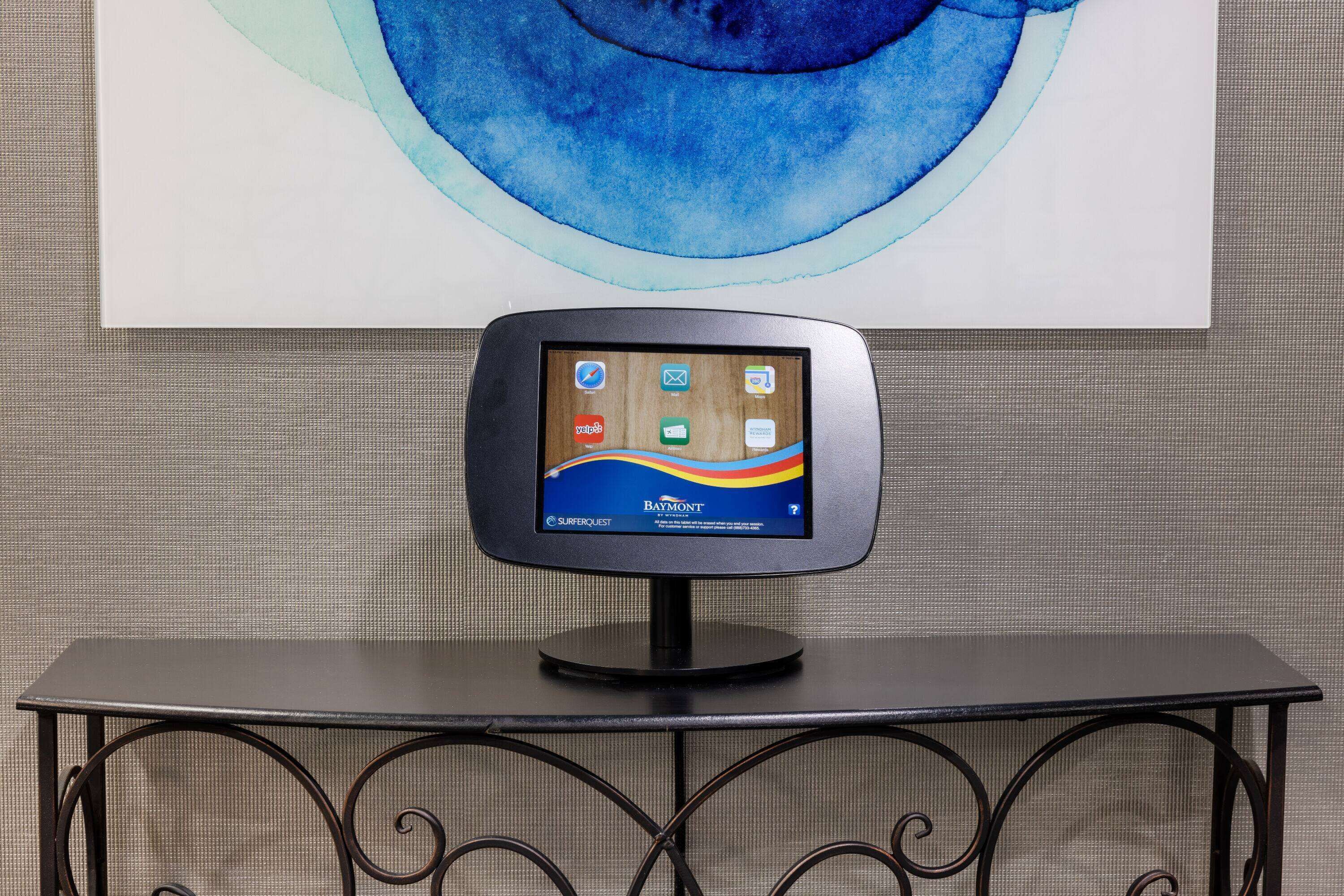 A Baymont® SURFERQUEST® kiosk on a black metal table with a simple, modern design.