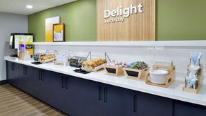 A breakfast bar with various food items and a coffee machine. - Spark by Hilton Dallas Medical District Love Field (Dallas)