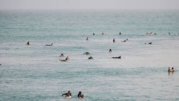 A large body of water with multiple people engaged in water activities.