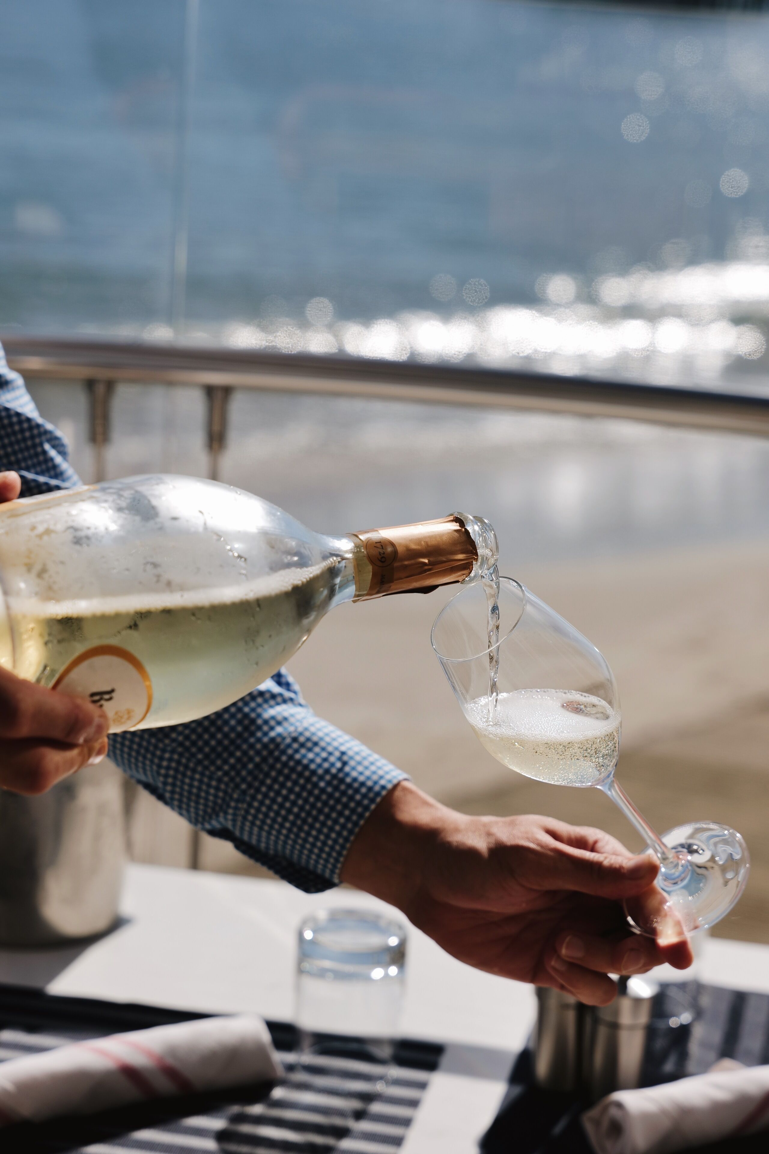 A person pouring champagne into a glass.