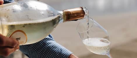 A person pouring champagne into a glass.