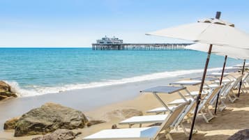 Private beach, white sand, sun loungers, beach umbrellas