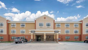 A hotel with a beige facade, multiple windows, and a lobby entrance. - Extended Stay America Suites Fort Wayne South (Fort Wayne)