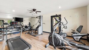 A gym with treadmills, elliptical machines, and weight equipment. - Best Western George West Executive Inn (George West)
